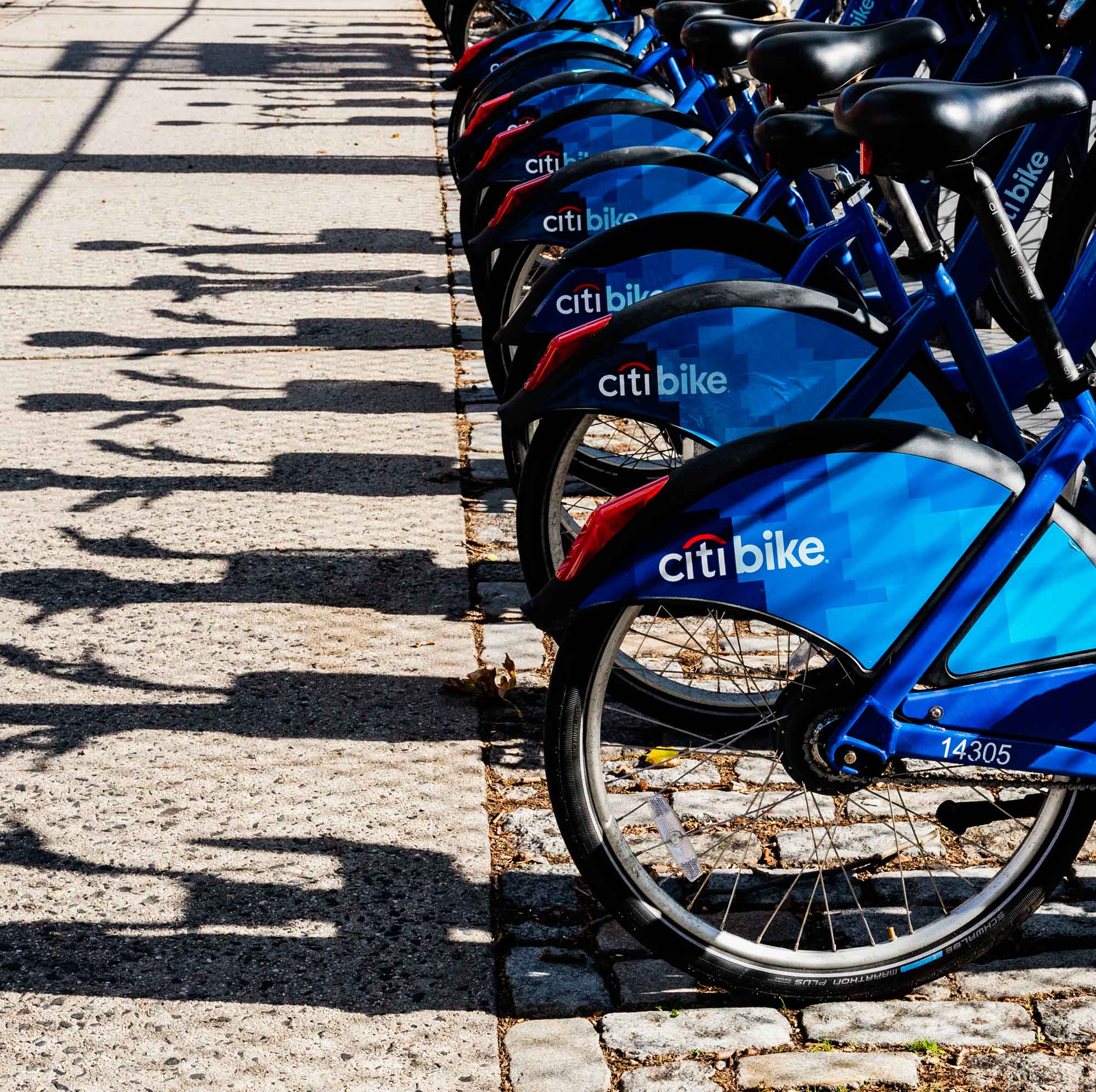 An image of a row of Citi Bikes in Greenpoint Landing near Two Blue Slip apartments.