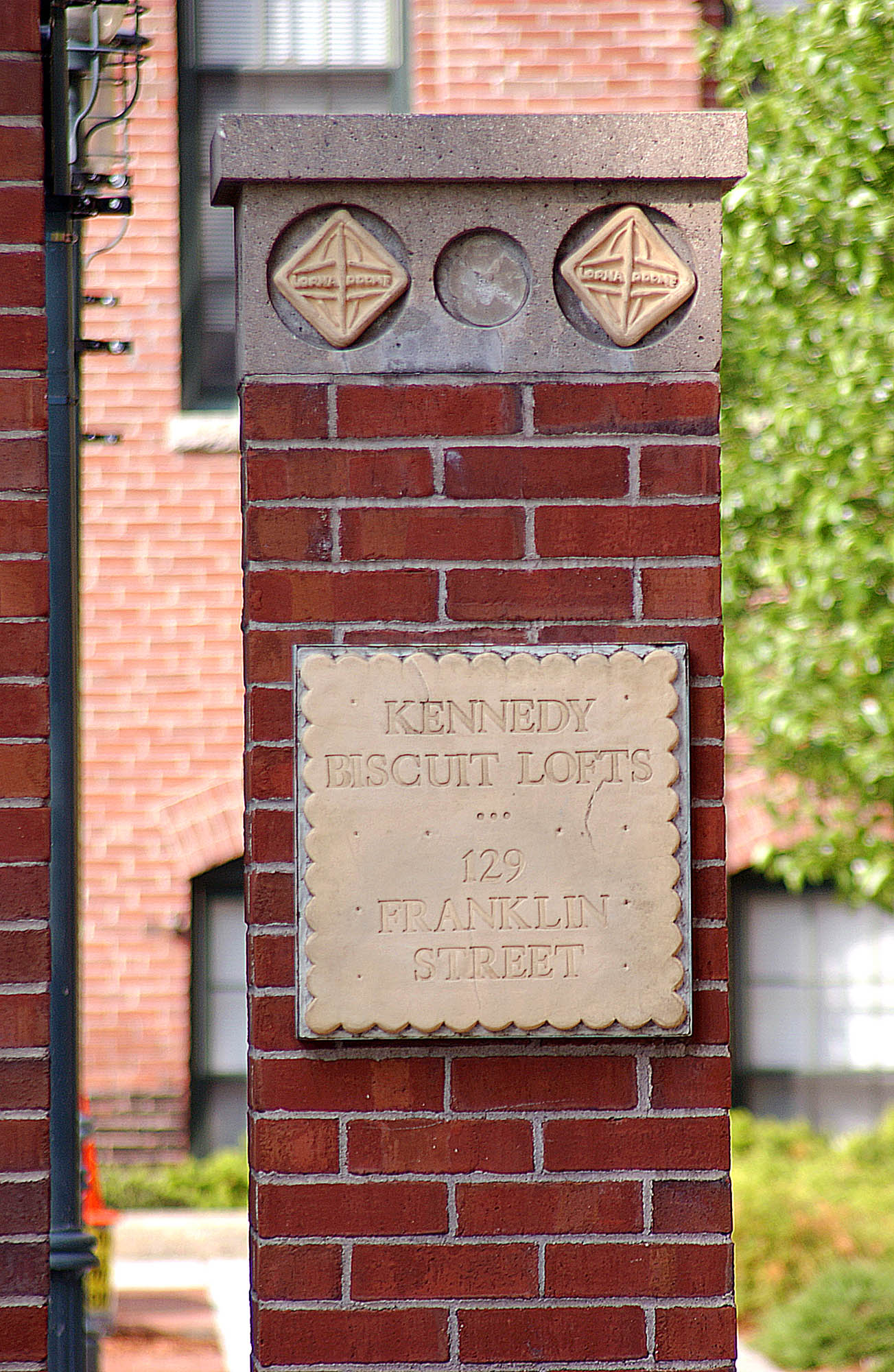 A sign showing the National Register of Historic Places at Kennedy Biscuit Lofts in Cambridge, Massachusetts.