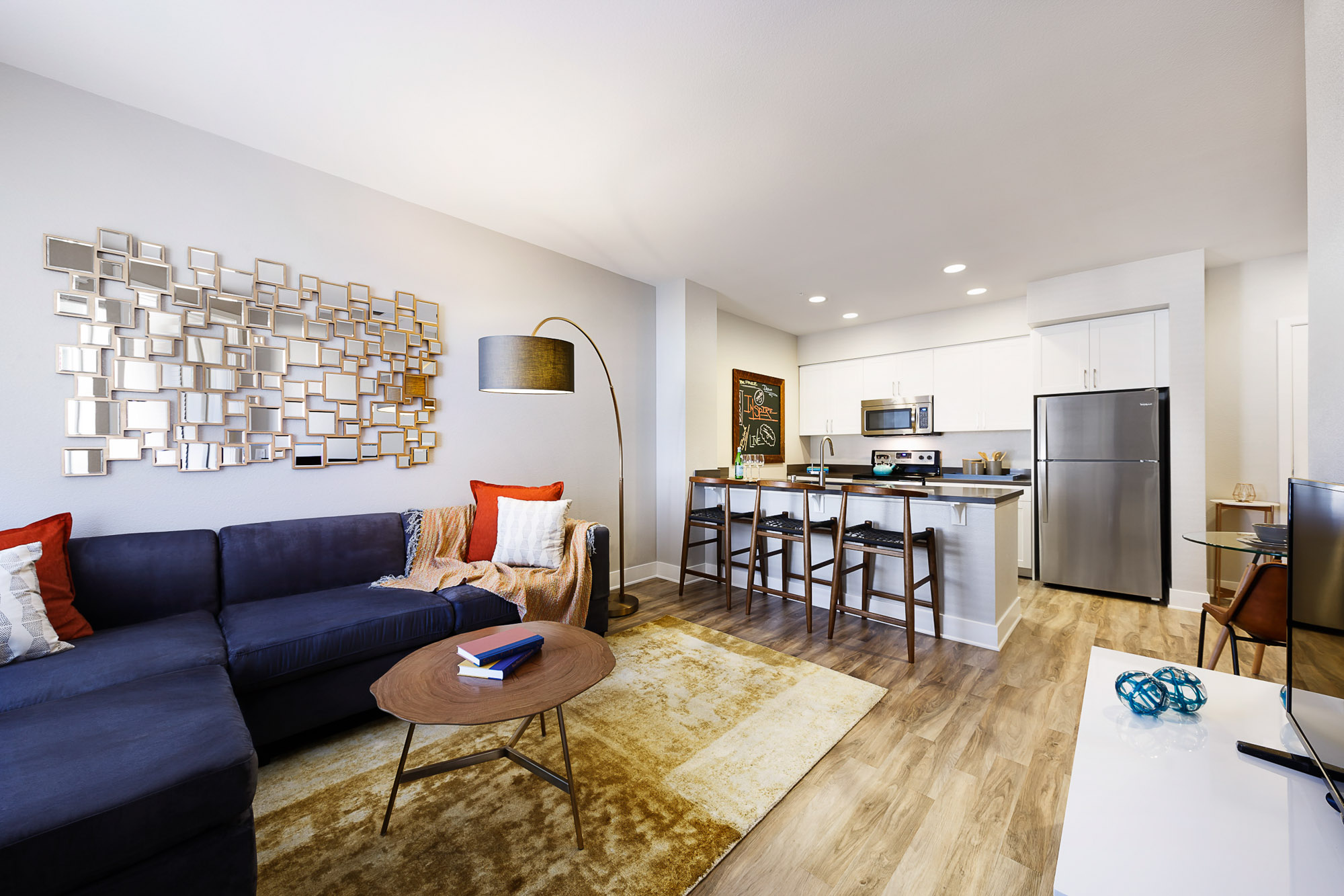 The living room and kitchen in an Alder apartment in Northridge, CA.