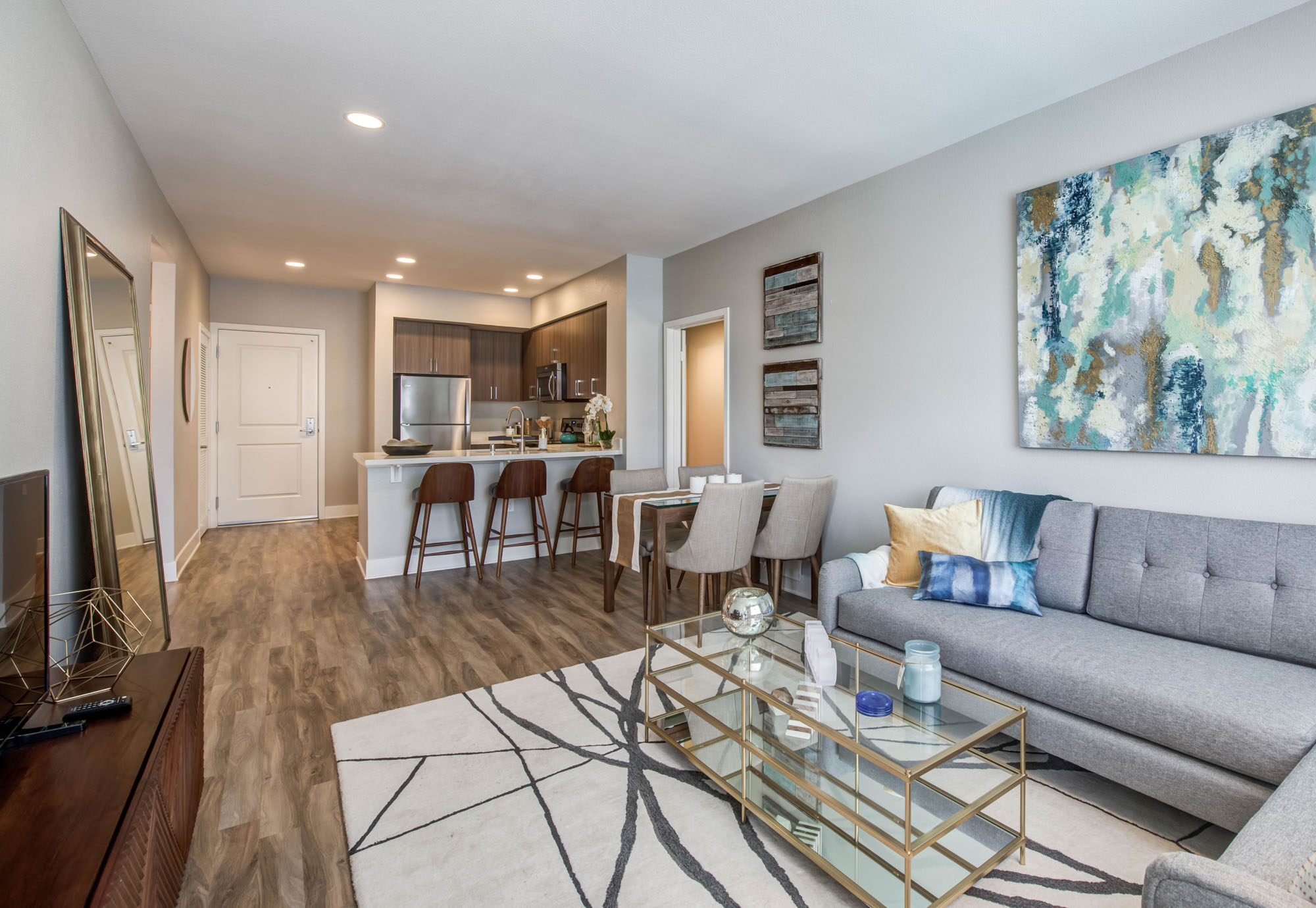 The living room and kitchen in an Alder apartment in Northridge, CA.